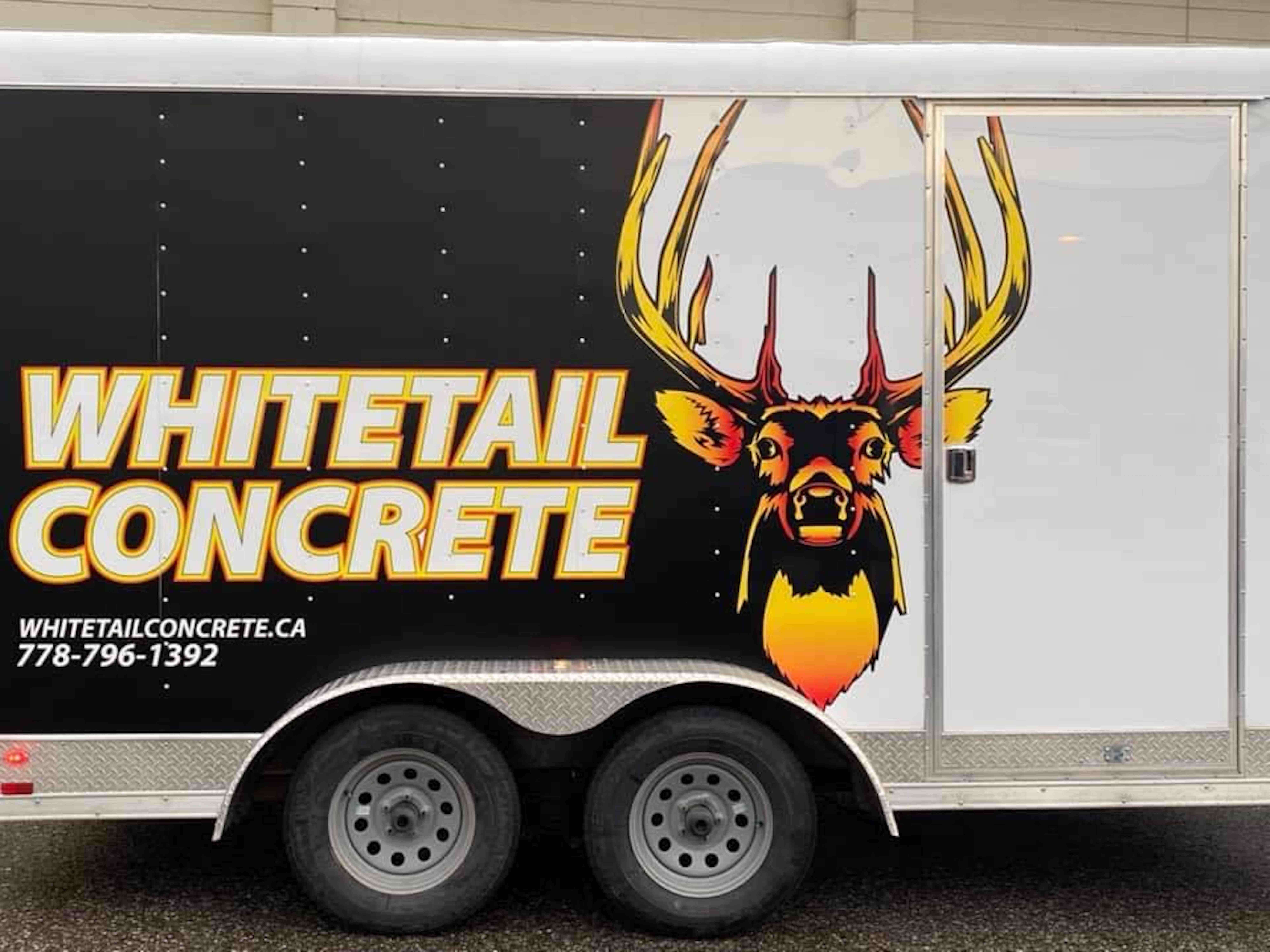 Whitetail concretes trailer with their logo on the side